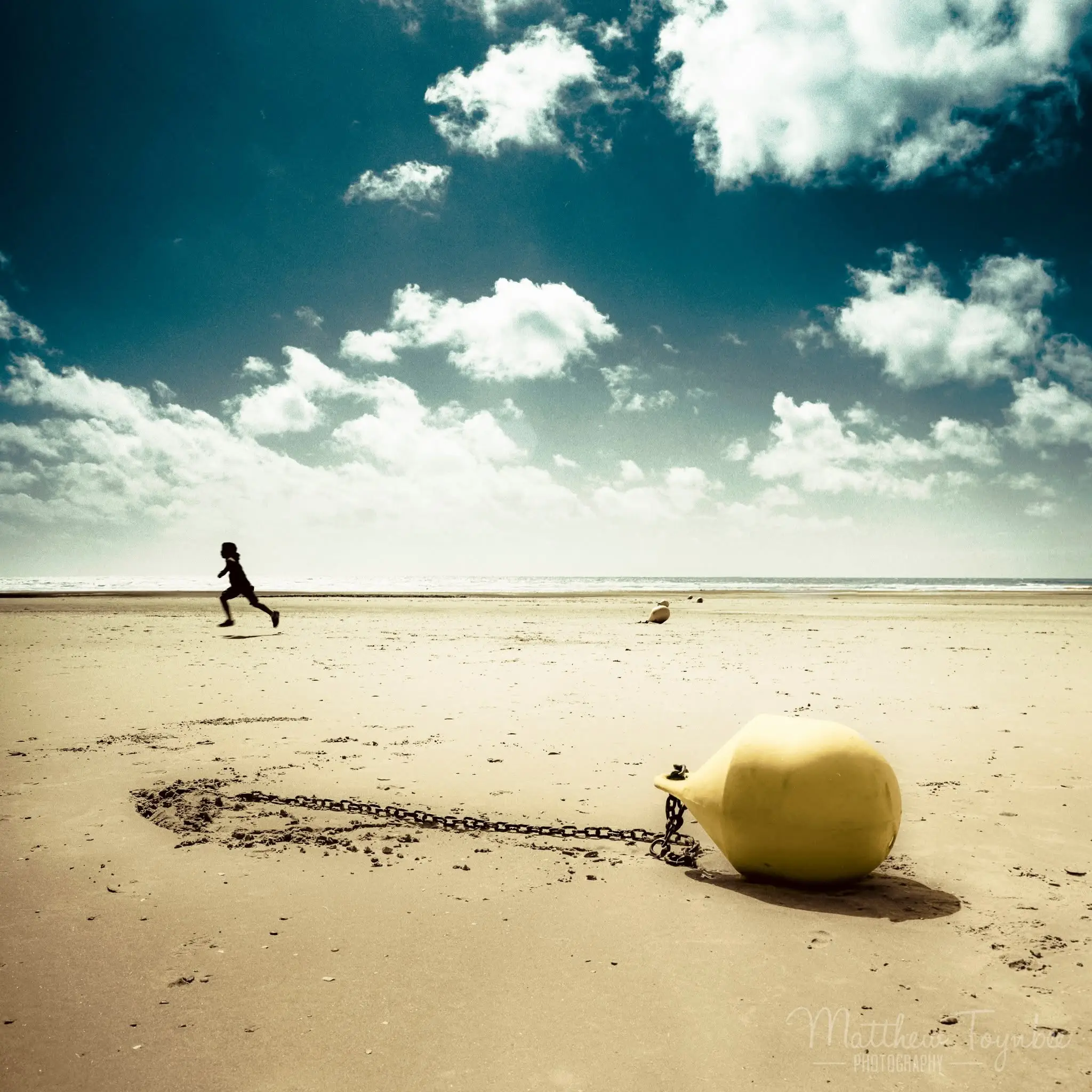 Child running on a beach, Golden Bay